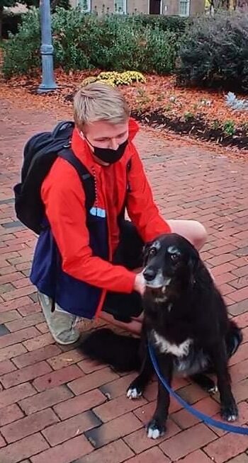 Student petting Bo the Wonder Dog