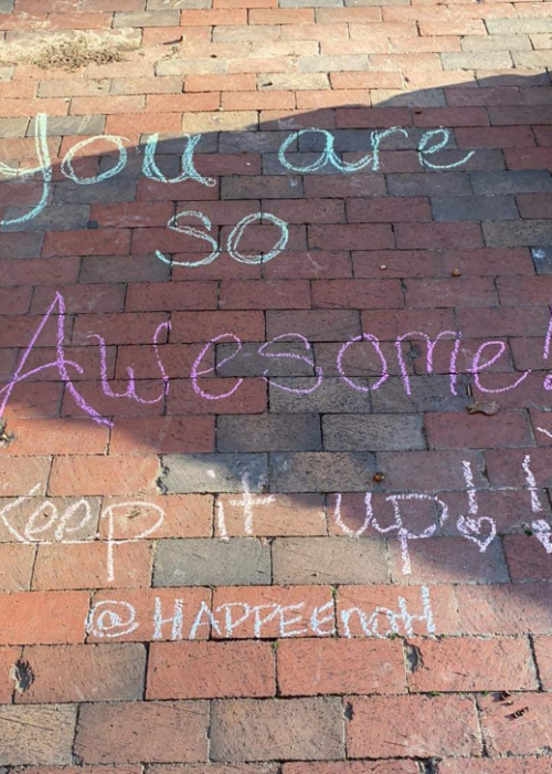 A chalked walk that says "You are so awesome! (Keep it up!) @HAPPEE.natl"