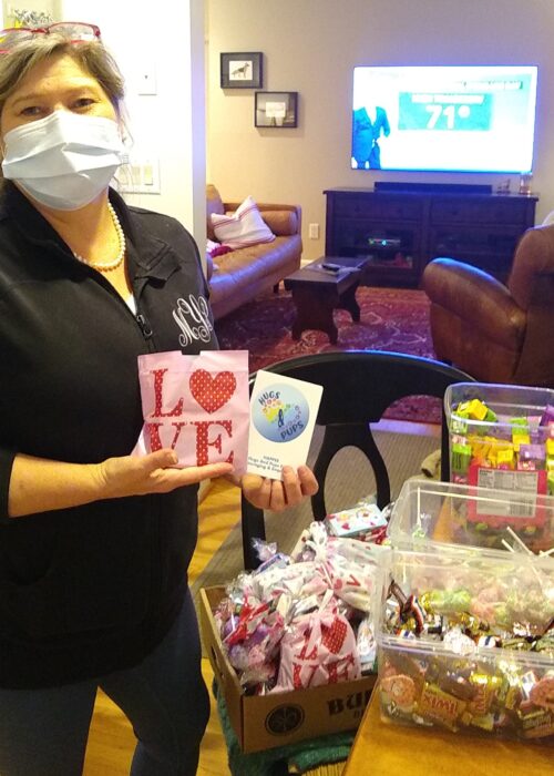 Michelle packing boxes of Valentine's themed bags with candy and goodies for the upcoming parade