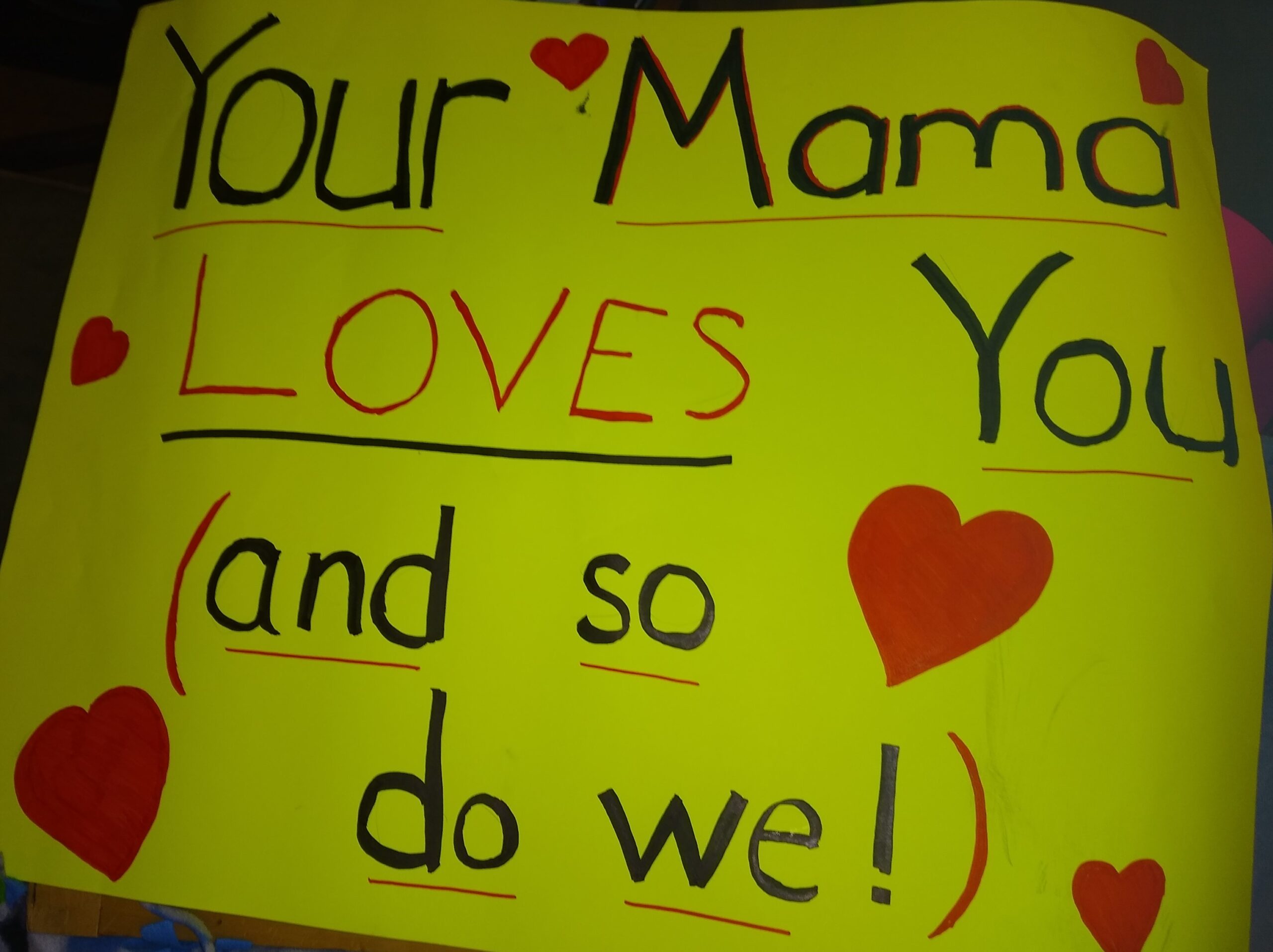 Yellow poster that says "Your Mama loves you (and so do we!)"